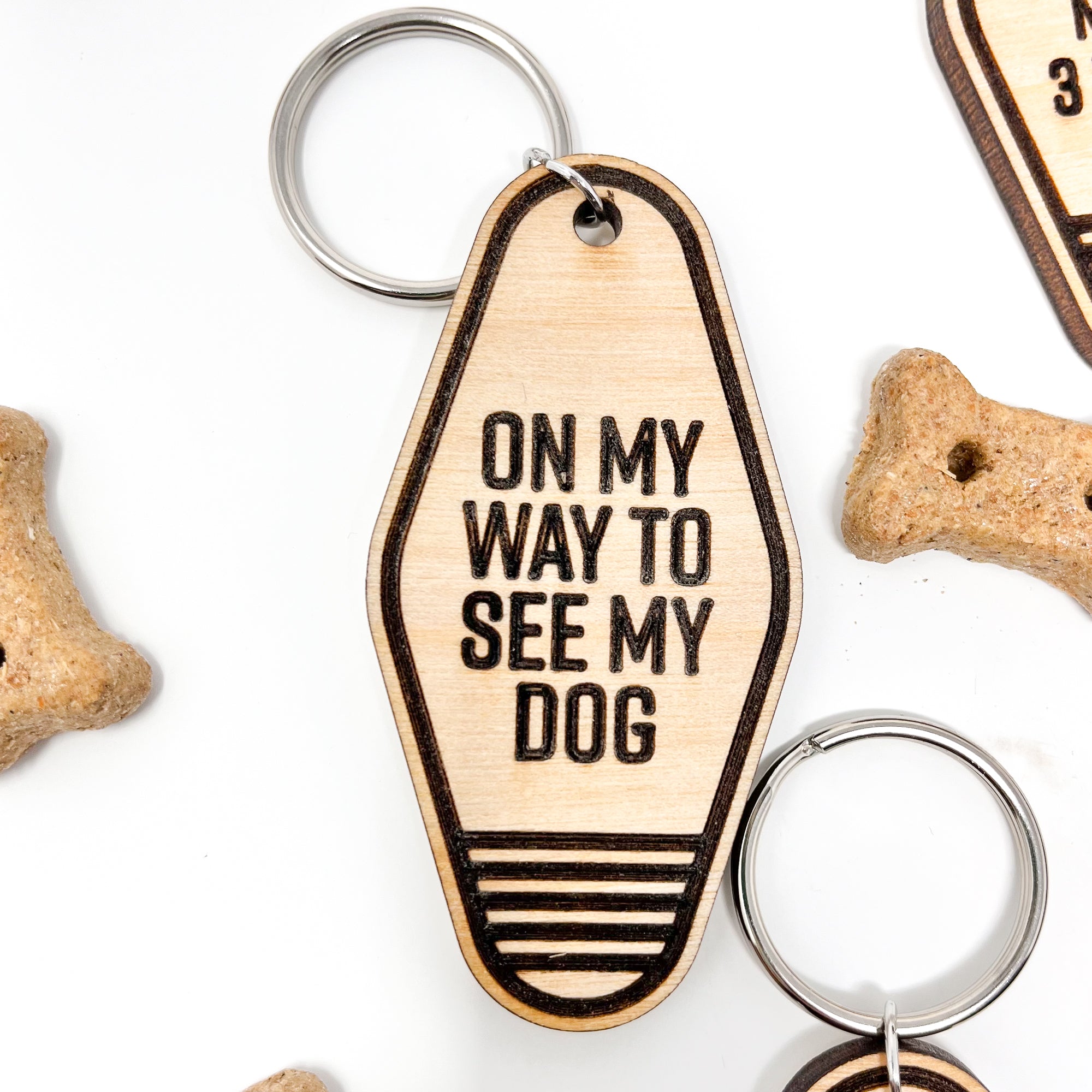 A collection of unique retro dog keychains made from natural wood, featuring laser-engraved designs and heartfelt messages for dog lovers.