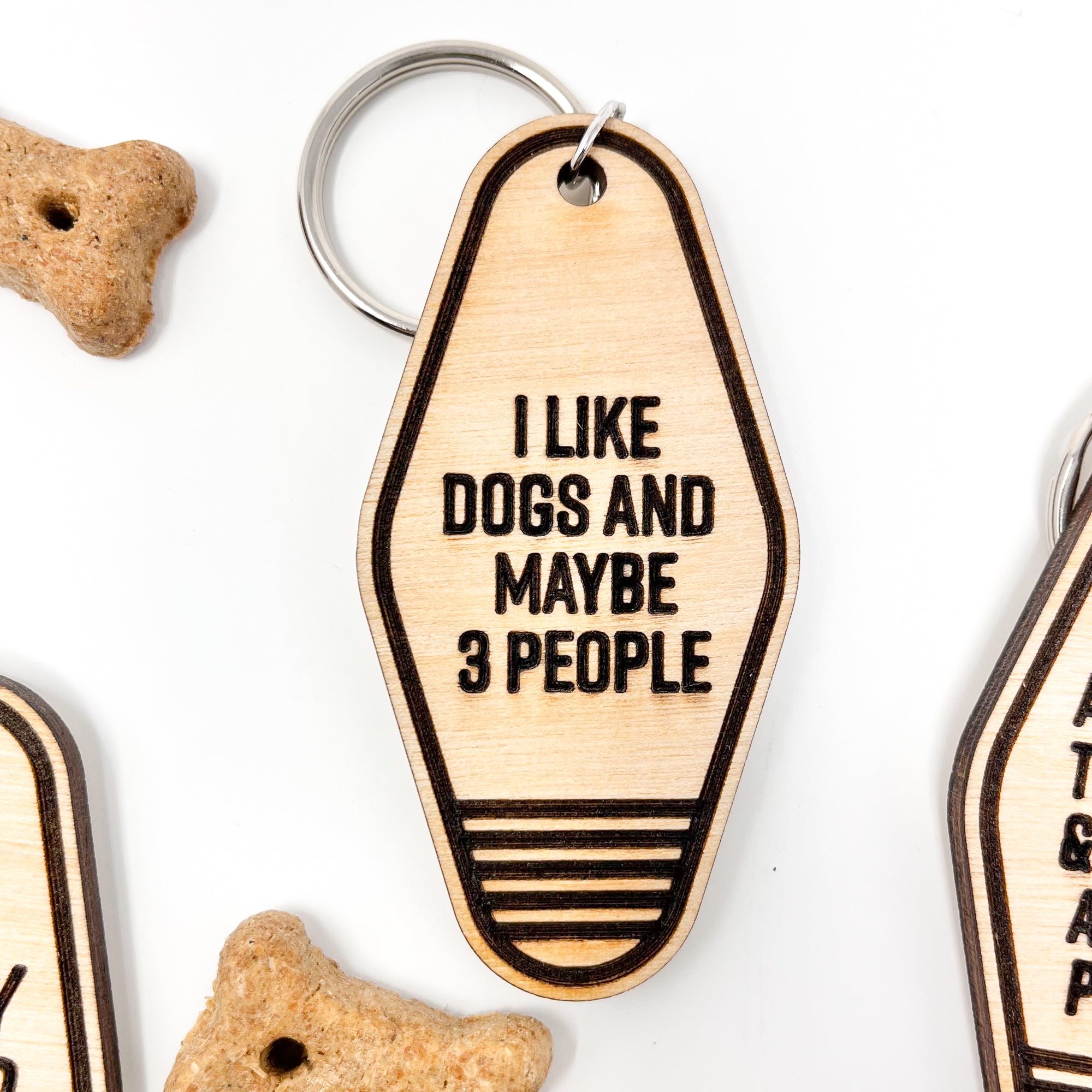 A collection of unique retro dog keychains made from natural wood, featuring laser-engraved designs and heartfelt messages for dog lovers.