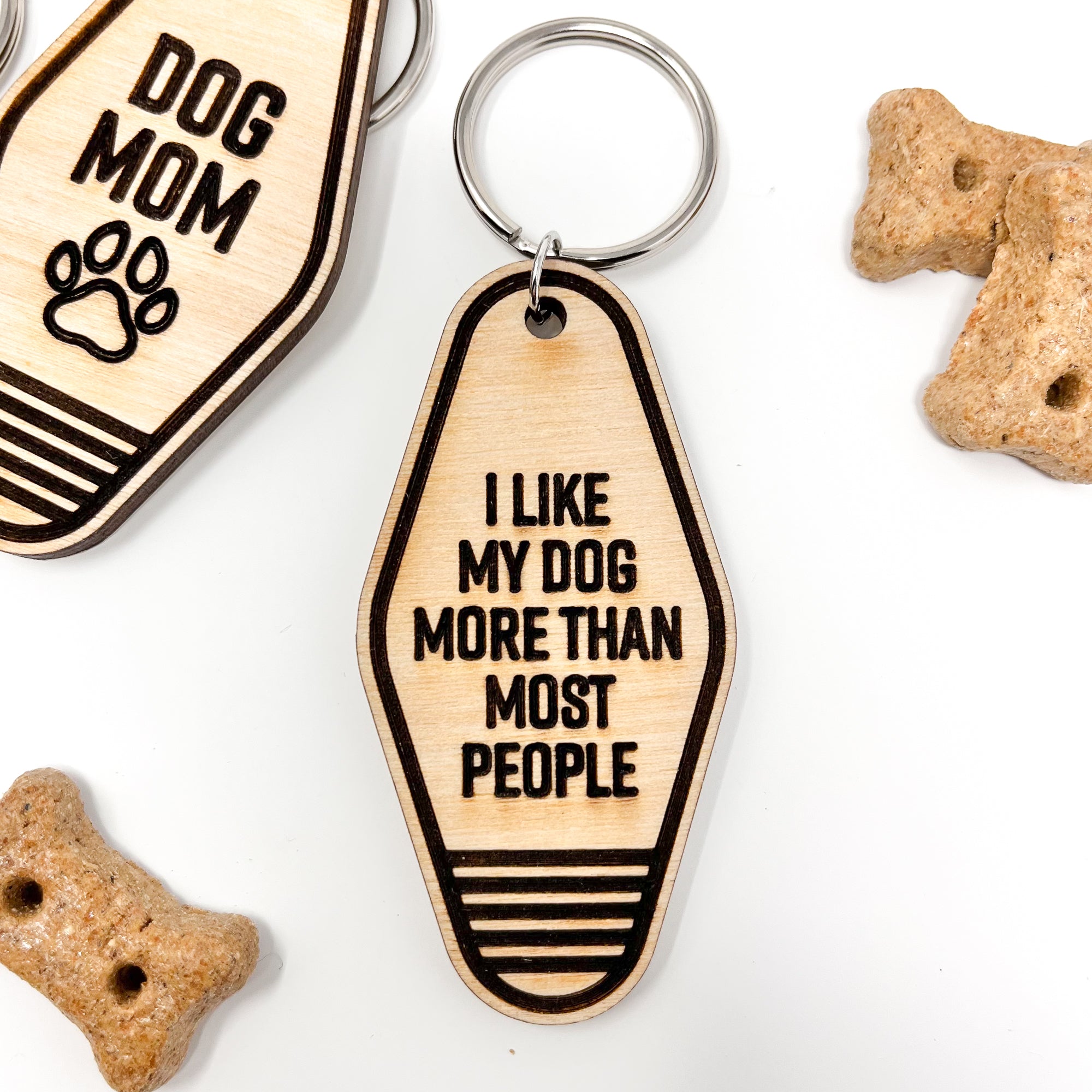 A collection of unique retro dog keychains made from natural wood, featuring laser-engraved designs and heartfelt messages for dog lovers.