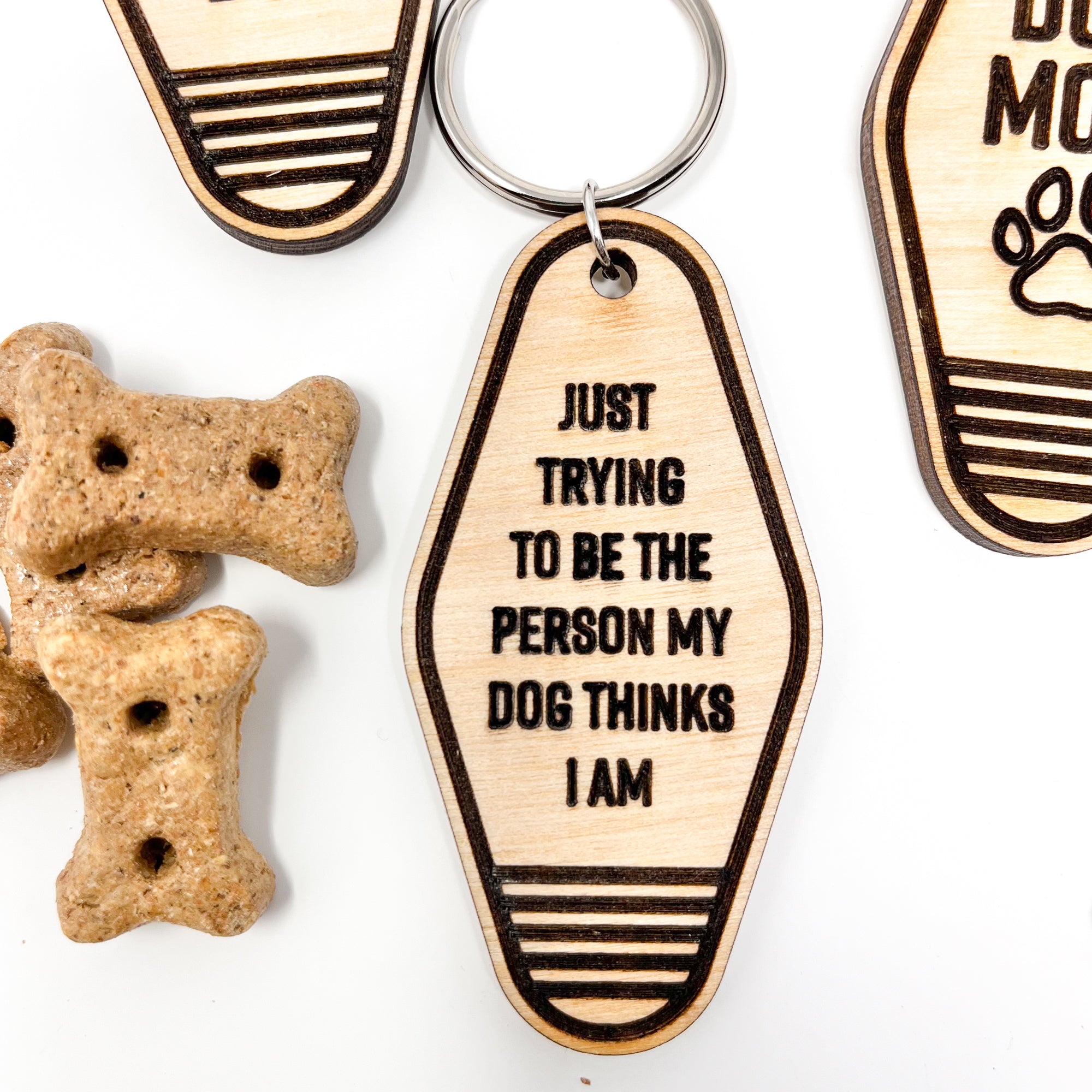 A collection of unique retro dog keychains made from natural wood, featuring laser-engraved designs and heartfelt messages for dog lovers.