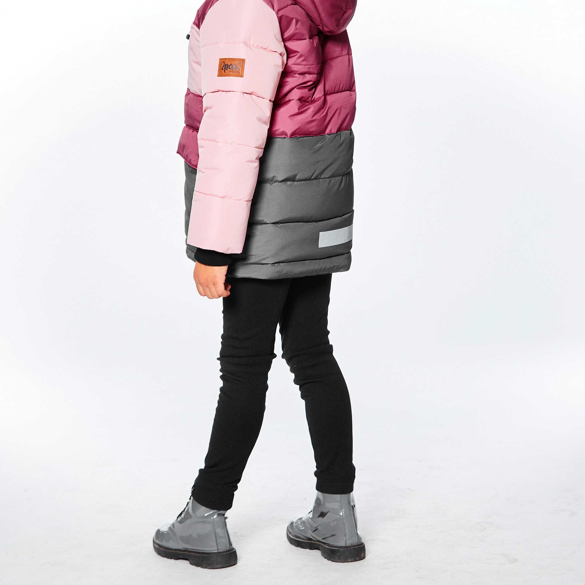 Child in tri-color puffer jacket.