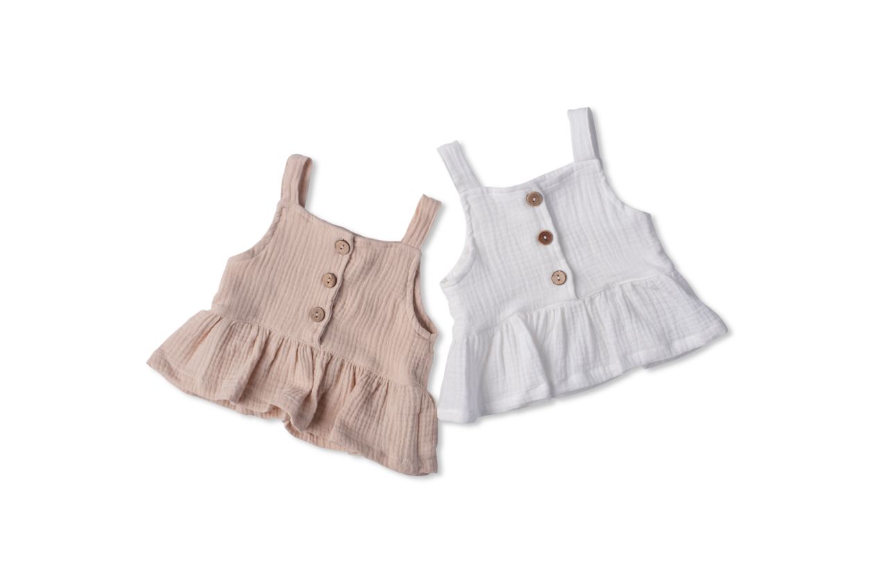 A soft cotton ruffle tank top in beige and white, perfect for layering and comfortable wear for children.