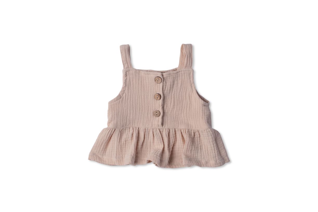 A soft cotton ruffle tank top in beige and white, perfect for layering and comfortable wear for children.