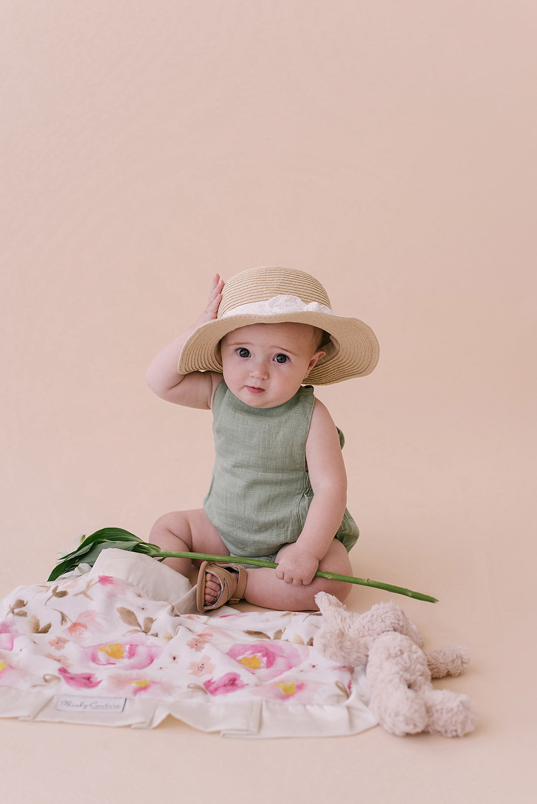 A stylish Sage Halter Romper made from soft linen, featuring diaper snaps and a chic halter design, perfect for babies.