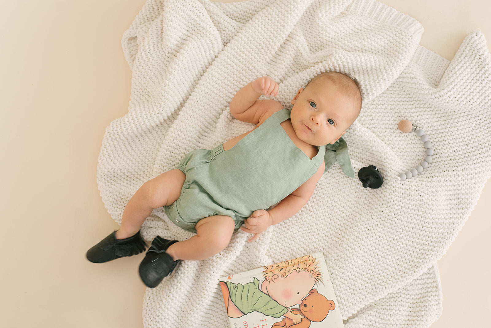 A stylish Sage Halter Romper made from soft linen, featuring diaper snaps and a chic halter design, perfect for babies.