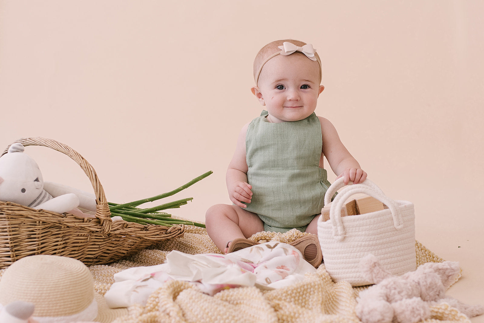 A stylish Sage Halter Romper made from soft linen, featuring diaper snaps and a chic halter design, perfect for babies.