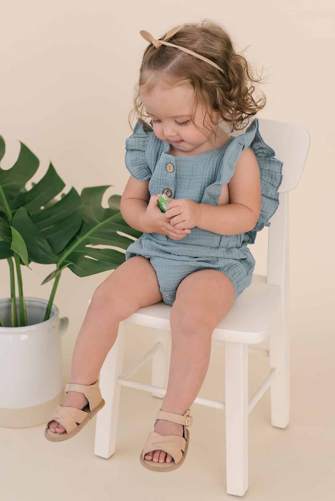 A stylish Seafoam Summer Romper made from soft linen, featuring diaper snaps and a classic design for babies.