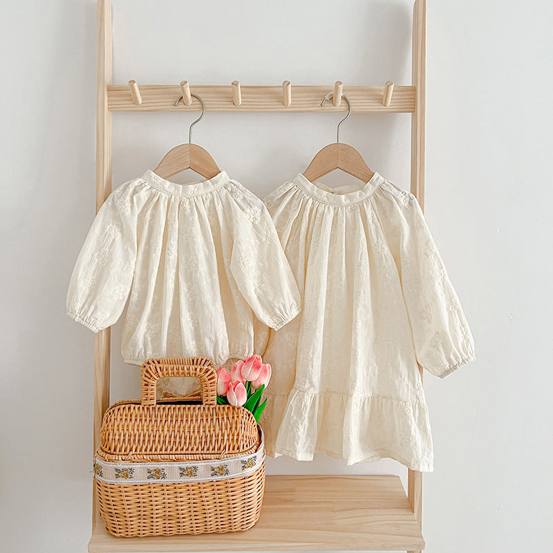 A beige and apricot floral baby onesie and dress set, featuring a round neck design, perfect for girls aged 3 months to 8 years.