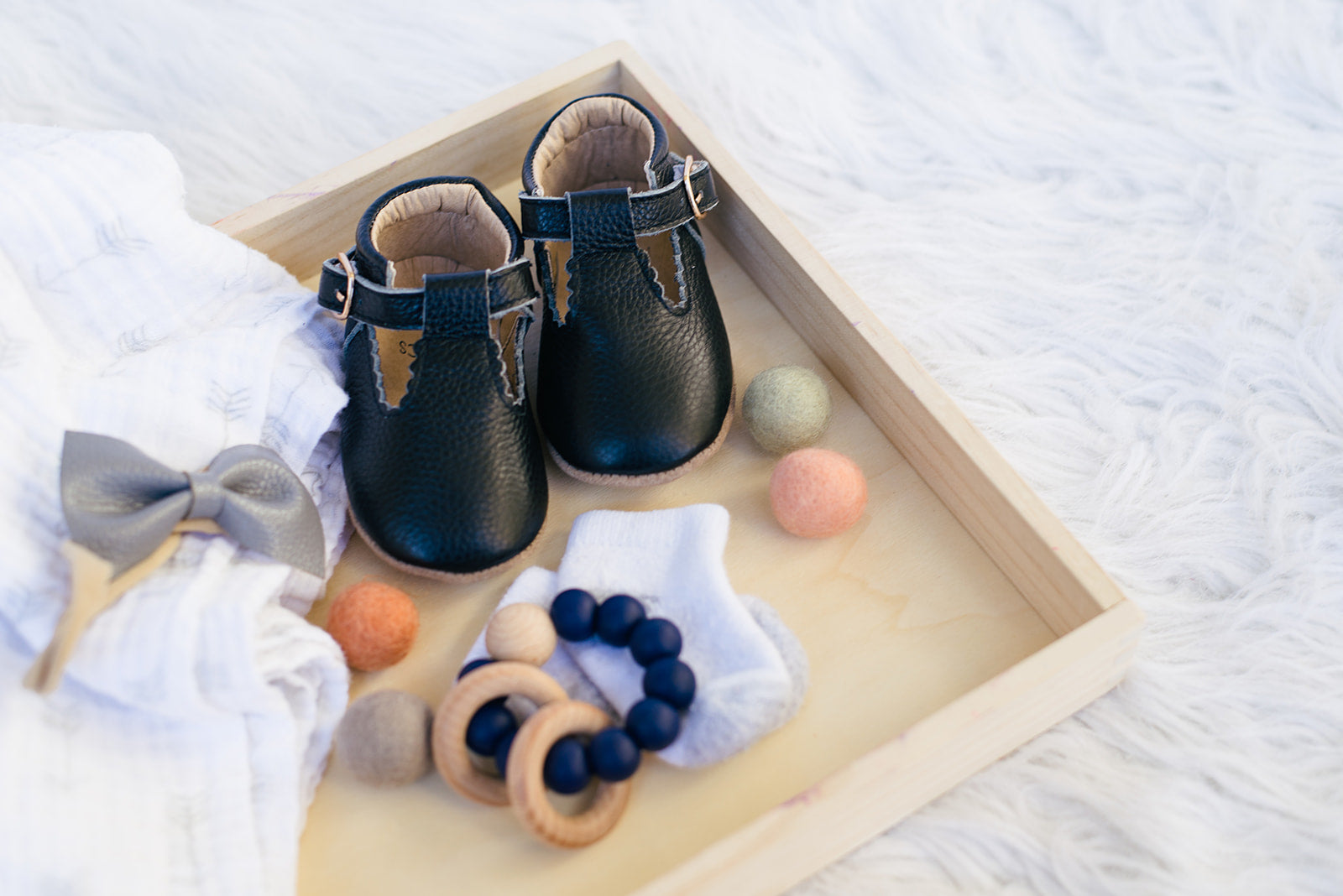 Soft-Sole Leather Mary Jane Moccasins in black, featuring a t-strap buckle design for easy wear and soft leather soles for comfort.