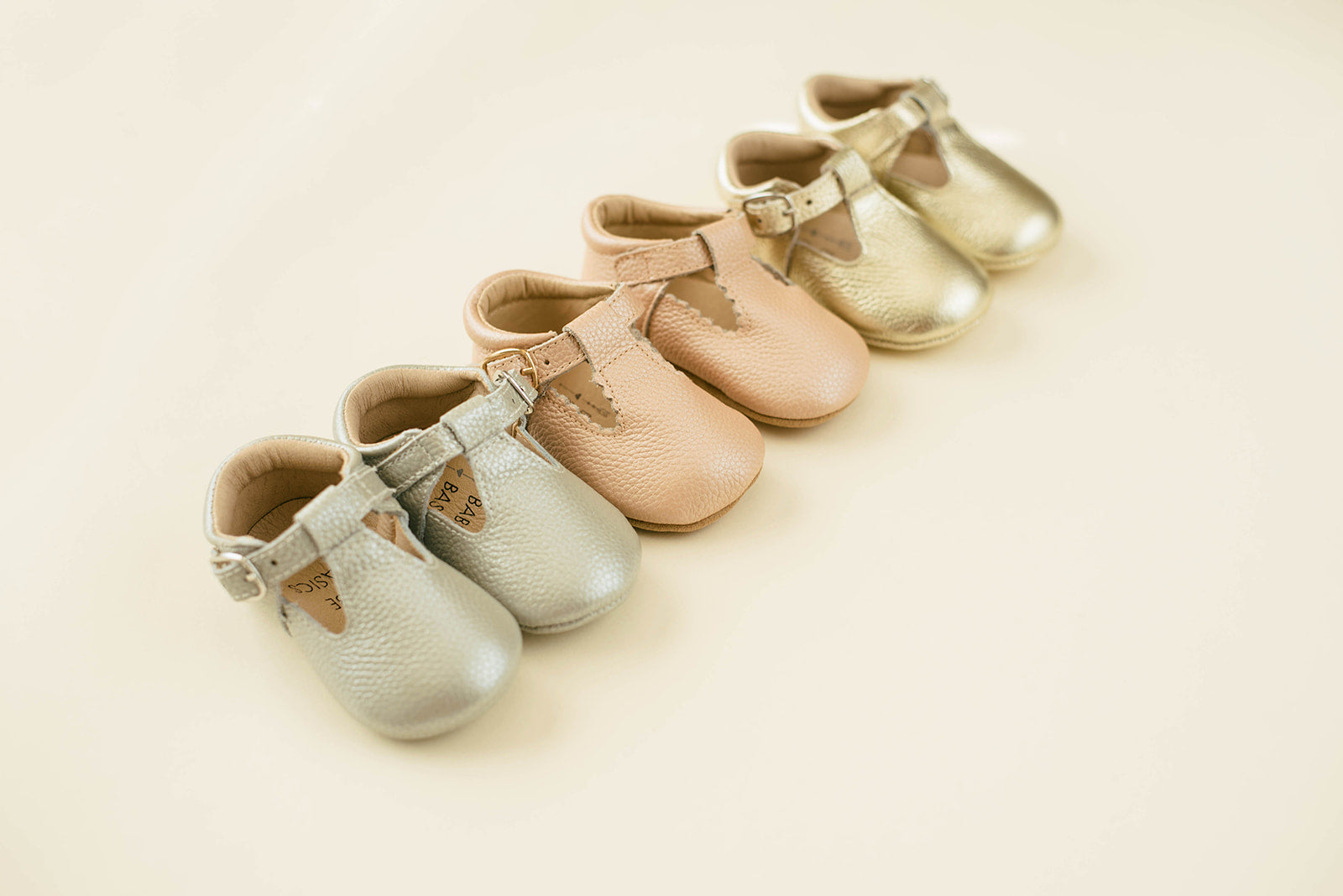 Soft-Sole Leather Mary Jane Moccasins in silver, featuring a t-strap buckle and soft leather soles for comfort.