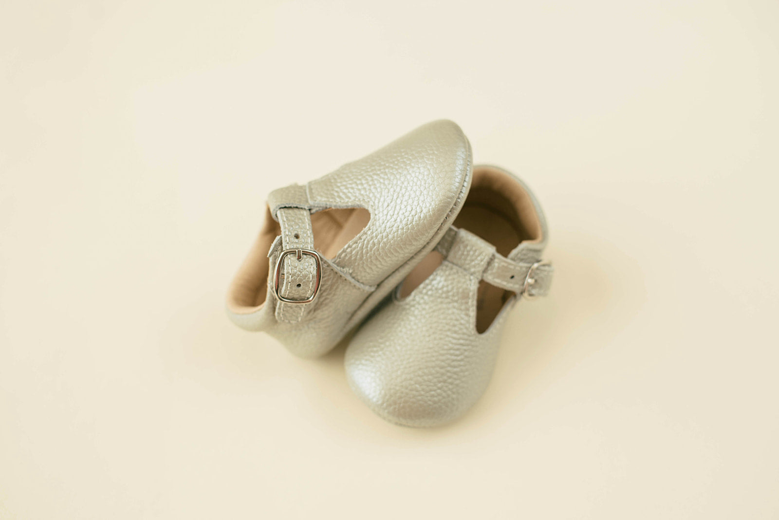 Soft-Sole Leather Mary Jane Moccasins in silver, featuring a t-strap buckle and soft leather soles for comfort.