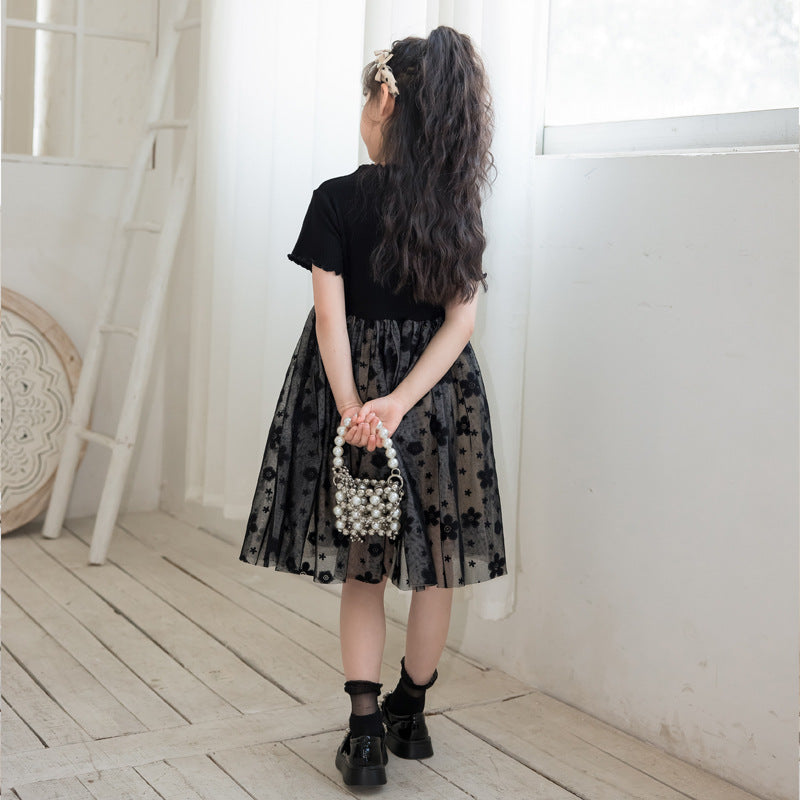 A stylish solid black short sleeve mesh dress for girls, perfect for summer wear, made from soft cotton material.