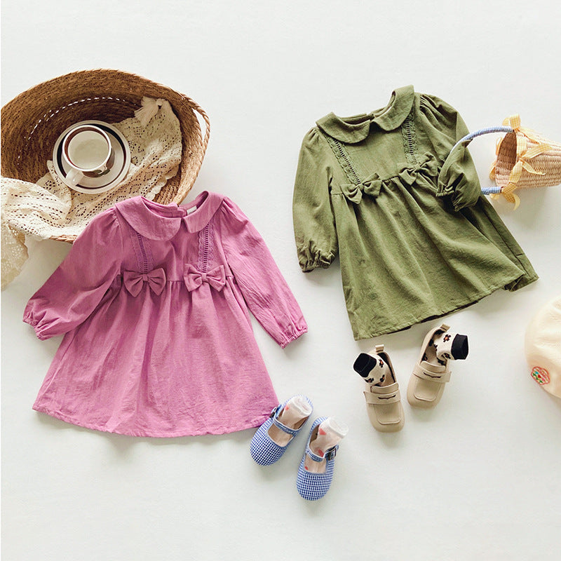 A stylish solid color dress for girls featuring mesh patches, available in pink and green, made from soft cotton material.