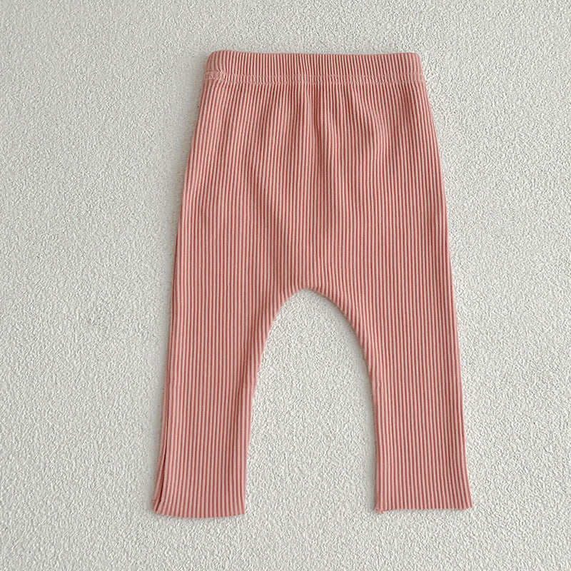 A pair of solid color soft cotton comfy leggings for baby girls, available in various colors including white, black, pink, blue, apricot, brown, and coffee.