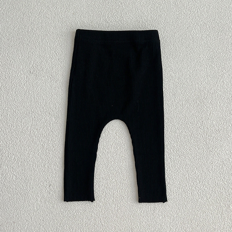 A pair of solid color soft cotton comfy leggings for baby girls, available in various colors including white, black, pink, blue, apricot, brown, and coffee.