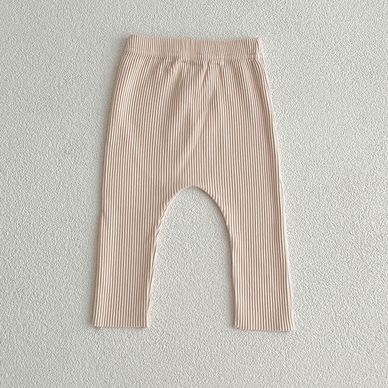 A pair of solid color soft cotton comfy leggings for baby girls, available in various colors including white, black, pink, blue, apricot, brown, and coffee.