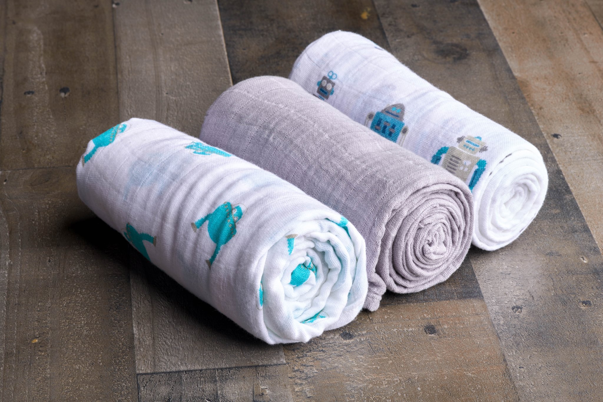 Space Robot Cotton Muslin Swaddle featuring playful robot design, soft and breathable fabric, perfect for baby care.