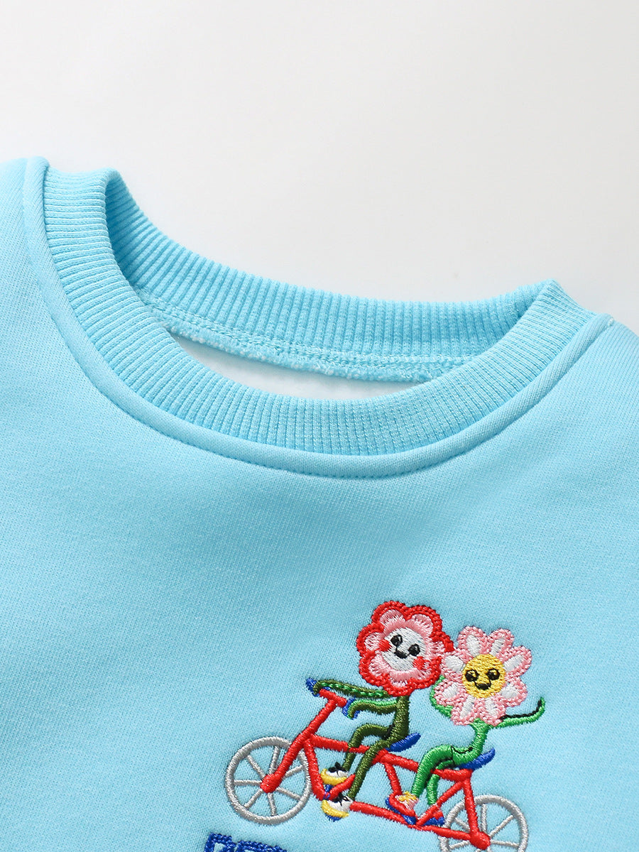 A blue long-sleeve top for girls featuring a colorful cartoon flowers pattern, made from cotton and polyester, perfect for spring and autumn wear.