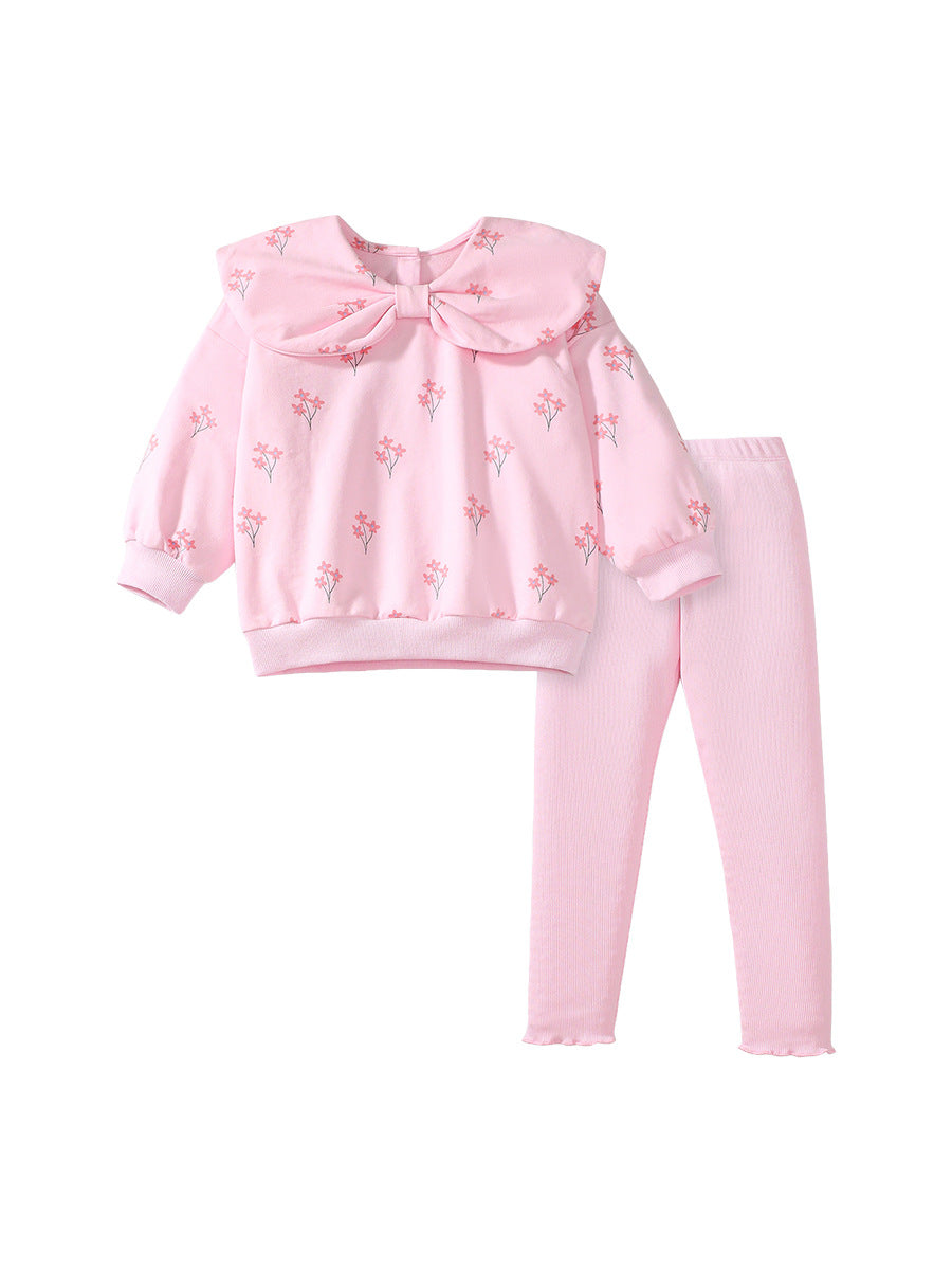 A cute pink long-sleeve top for girls featuring a floral print and bow-shaped detail, perfect for spring and autumn wear.