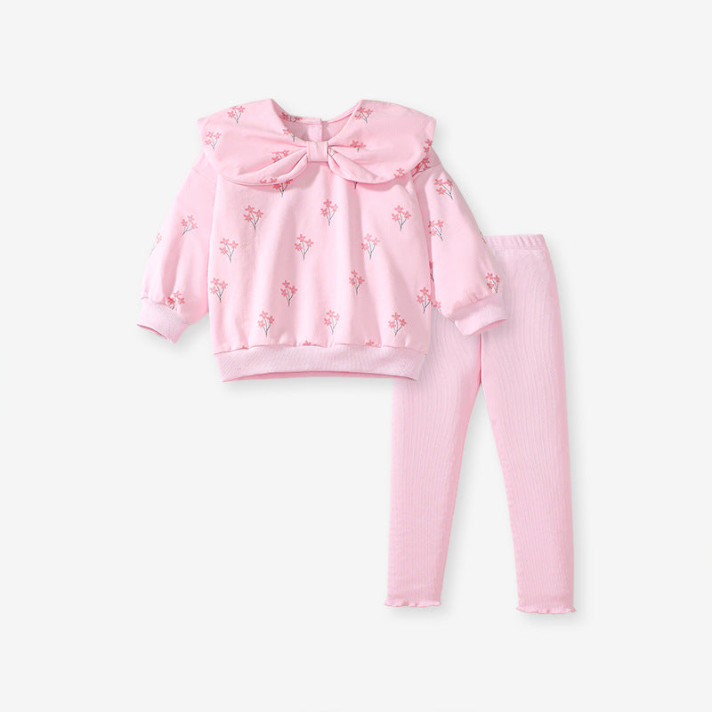 A cute pink long-sleeve top for girls featuring a floral print and bow-shaped detail, perfect for spring and autumn wear.