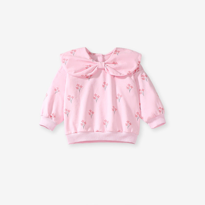 A cute pink long-sleeve top for girls featuring a floral print and bow-shaped detail, perfect for spring and autumn wear.