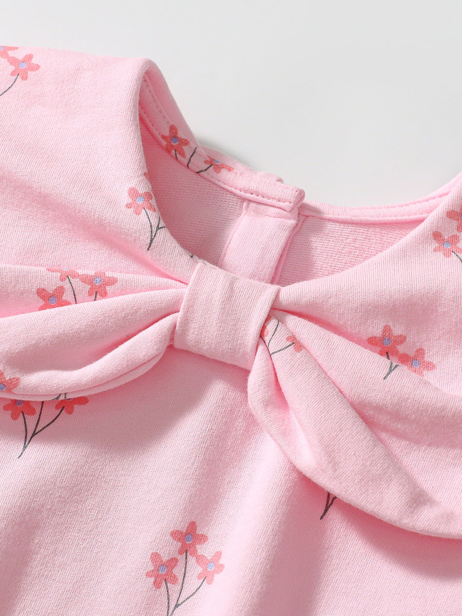 A cute pink long-sleeve top for girls featuring a floral print and bow-shaped detail, perfect for spring and autumn wear.