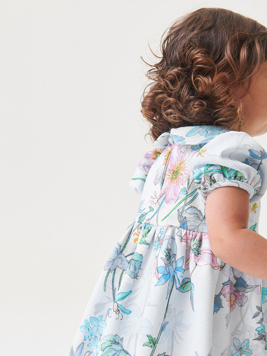 A beautiful white floral dress for baby girls featuring a Peter Pan collar and short sleeves, perfect for spring and summer wear.