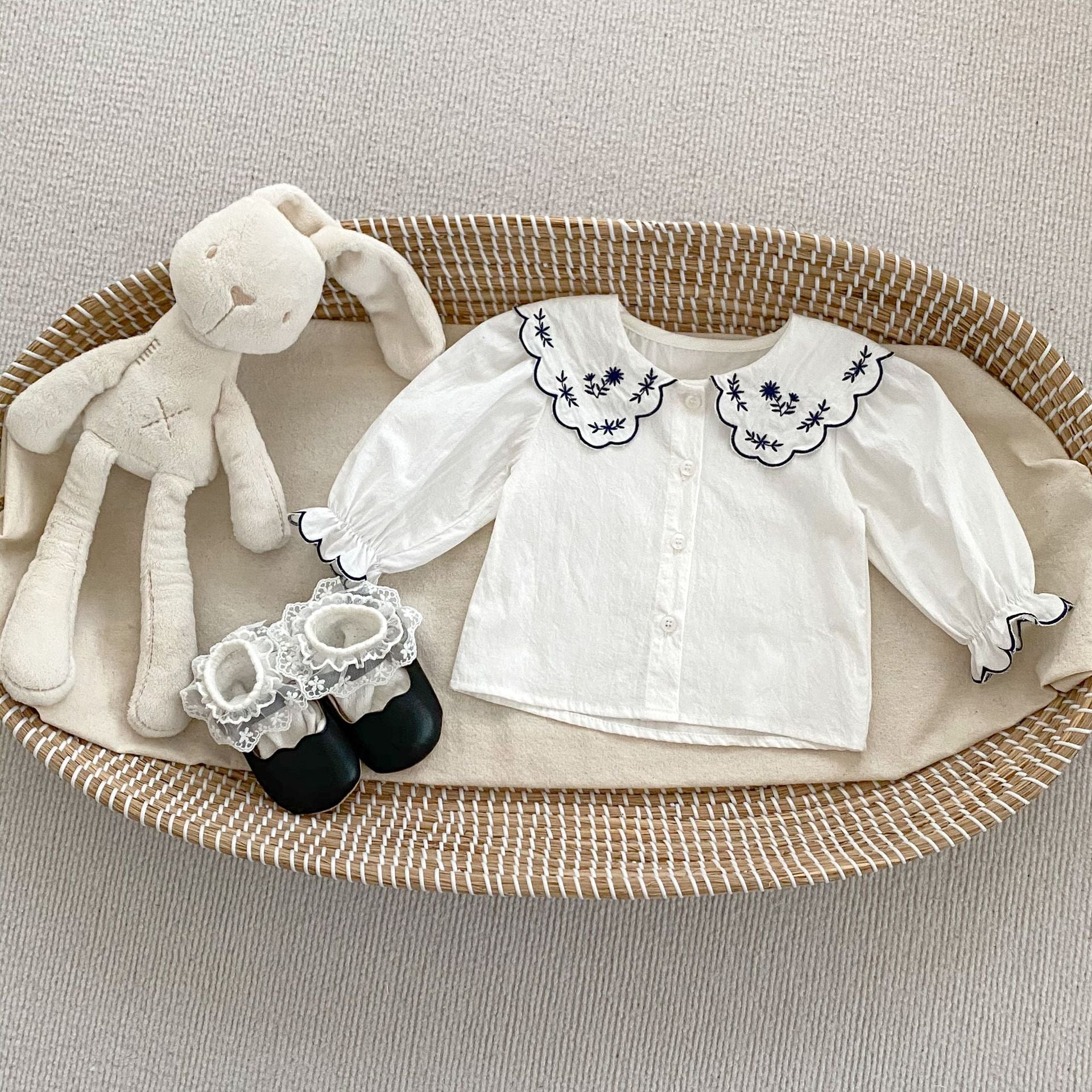 A stylish vintage white shirt with floral patterns paired with elegant black leather shoes for baby girls, perfect for spring and autumn.