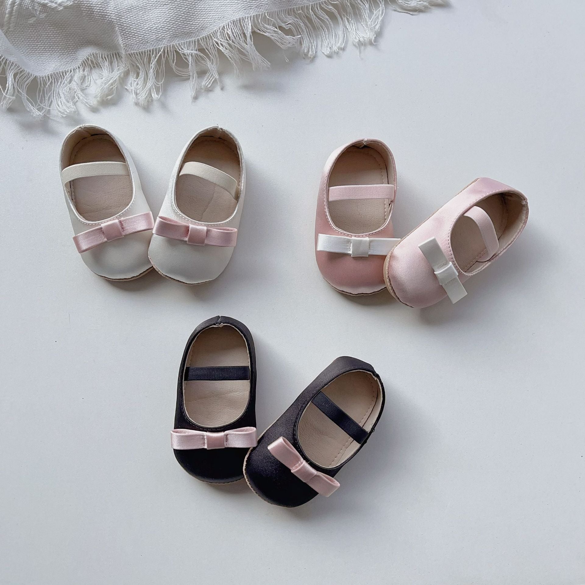 Spring Baby Girl Cute Bow Toddler Soft-Sole Anti-Slip Walking Shoes in white, black, and pink colors with a charming bow design.