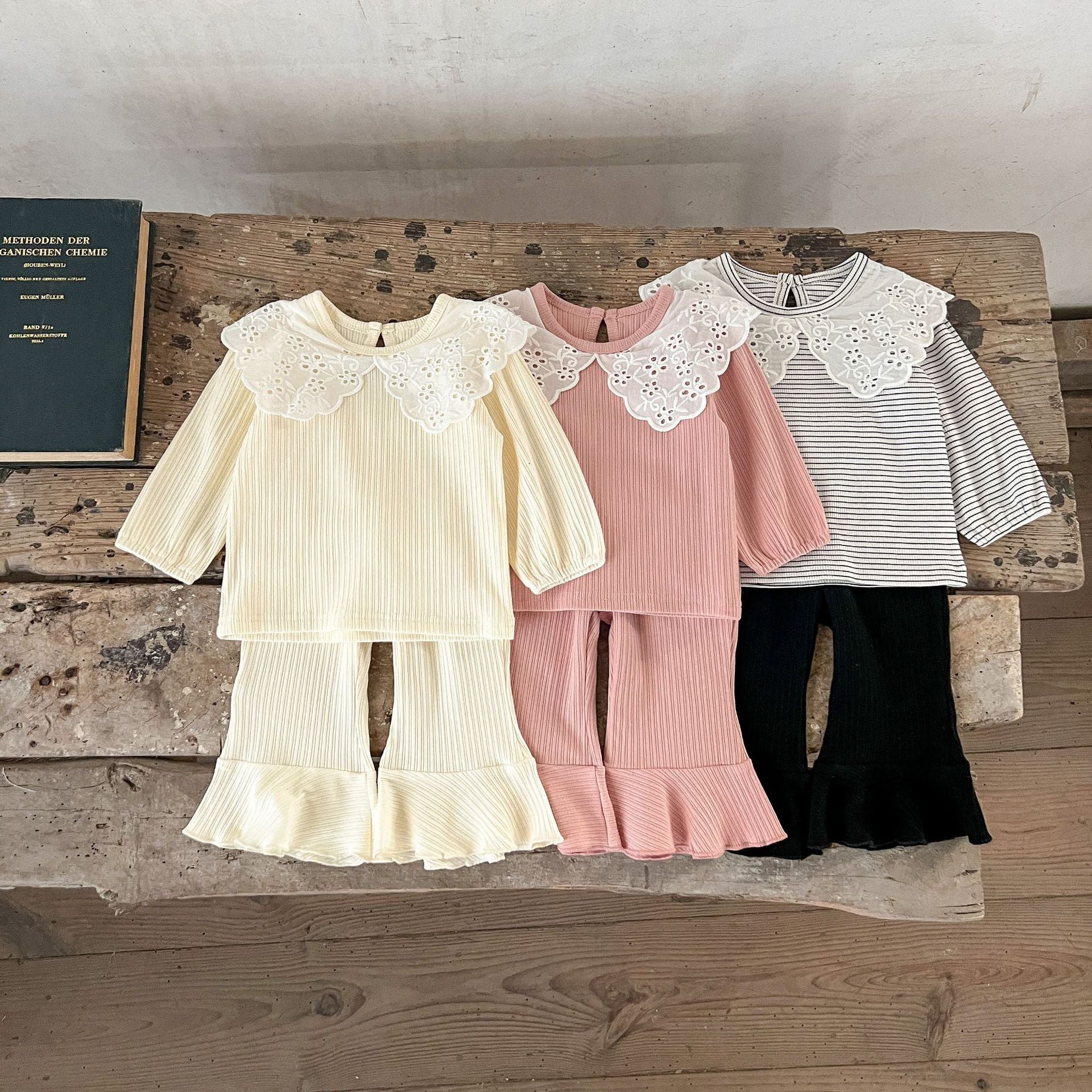 Spring Baby Kids Girls Hollow-Out Collar Top and Flared Pants set in various colors, showcasing stylish design and comfortable fabric.