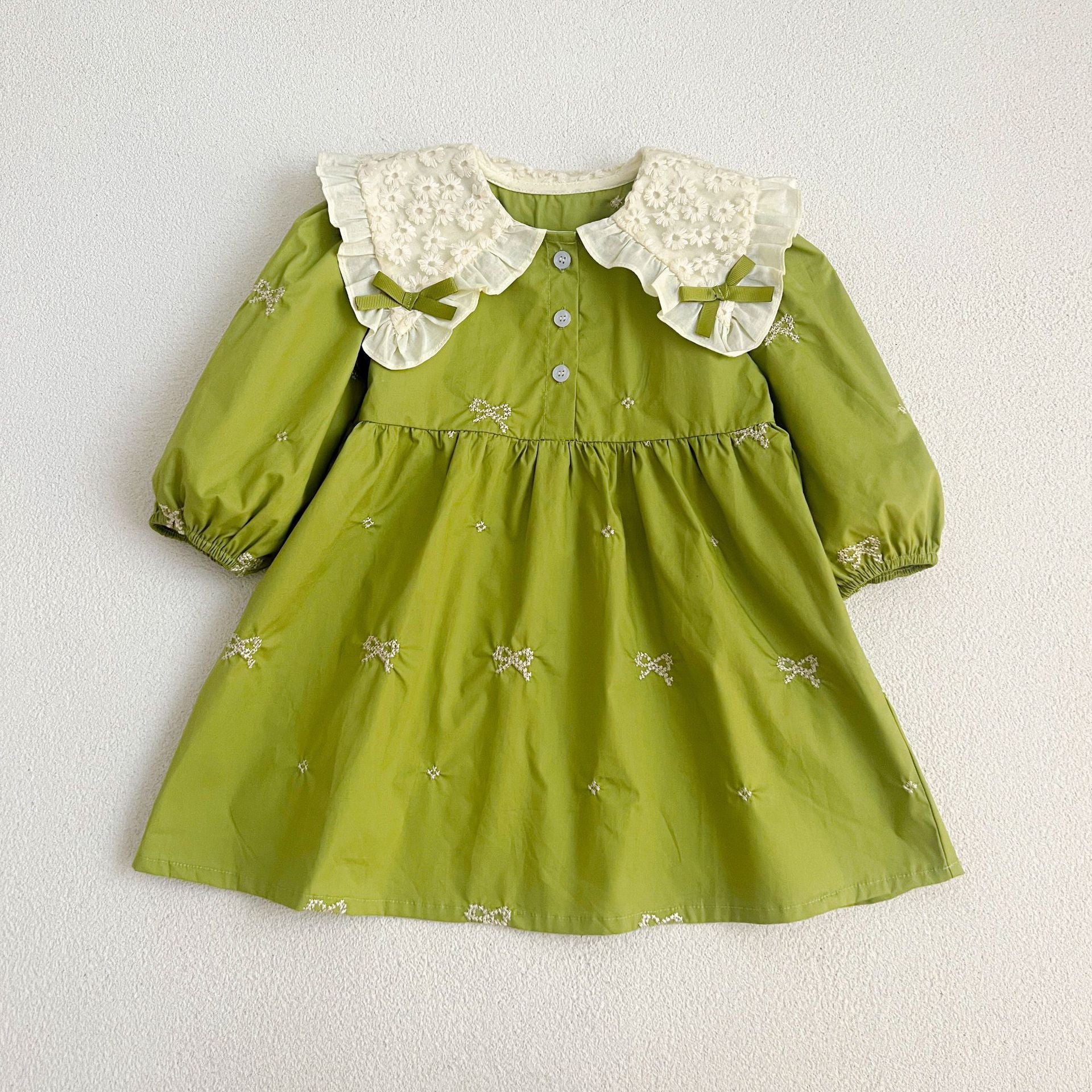 A stylish long sleeve green dress for girls featuring a mesh patched design and embroidered details, perfect for spring and autumn wear.