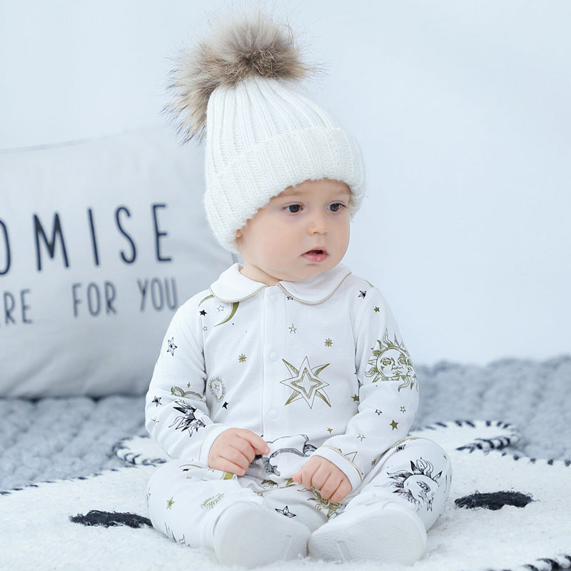 Baby outfit featuring suns, moons, and stars print in white cotton, perfect for spring and autumn.