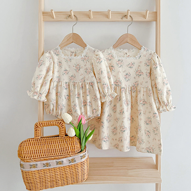 A stylish square neck baby onesie in white and beige, featuring floral embroidery, perfect for baby girls.