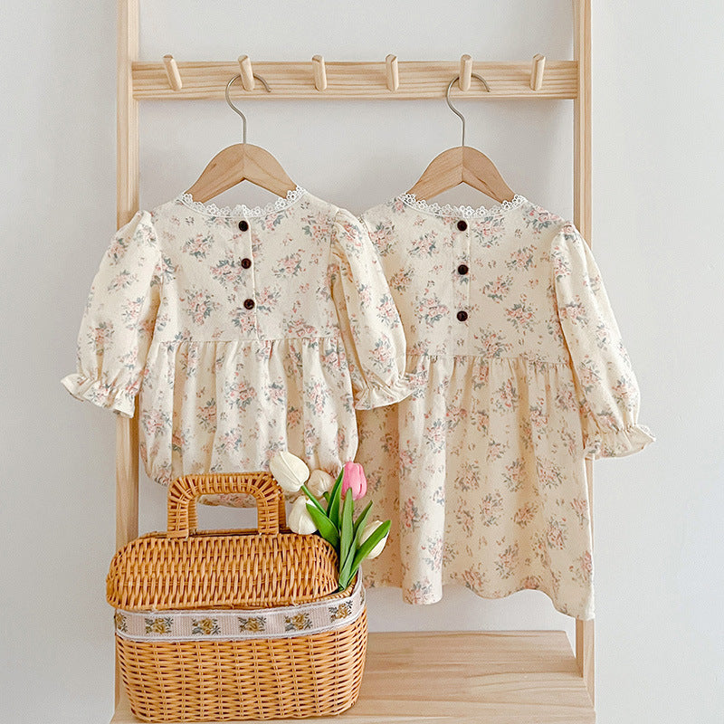 A stylish square neck baby onesie in white and beige, featuring floral embroidery, perfect for baby girls.