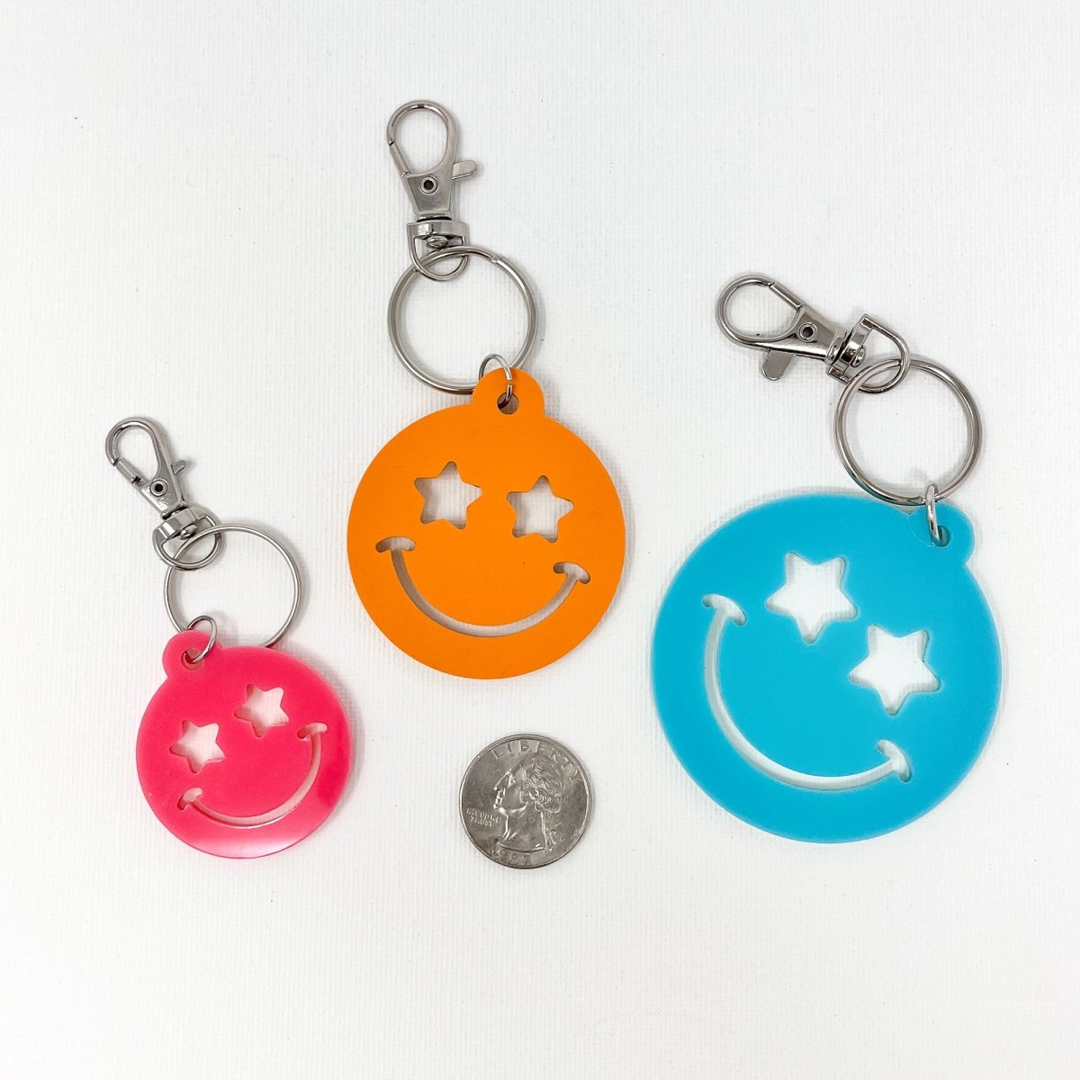 Colorful Stars Smiley Face Keychain made of acrylic, featuring a cheerful smiley face design, available in multiple sizes.