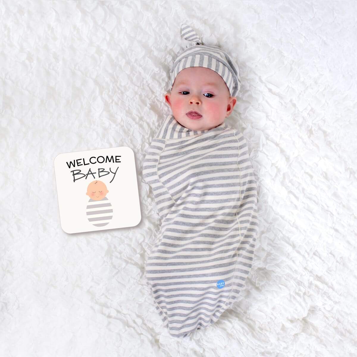 Stripe Baby cocoon swaddle set including swaddle, headpiece, and announcement card, designed for newborns.