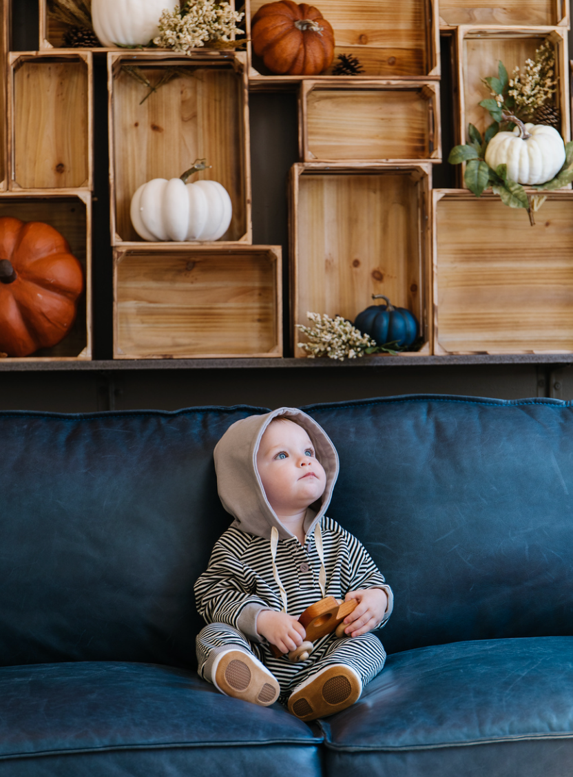 A cozy Hooded Striped Sweatshirt Jumpsuit for babies, featuring a trendy striped pattern and a convenient front zipper.