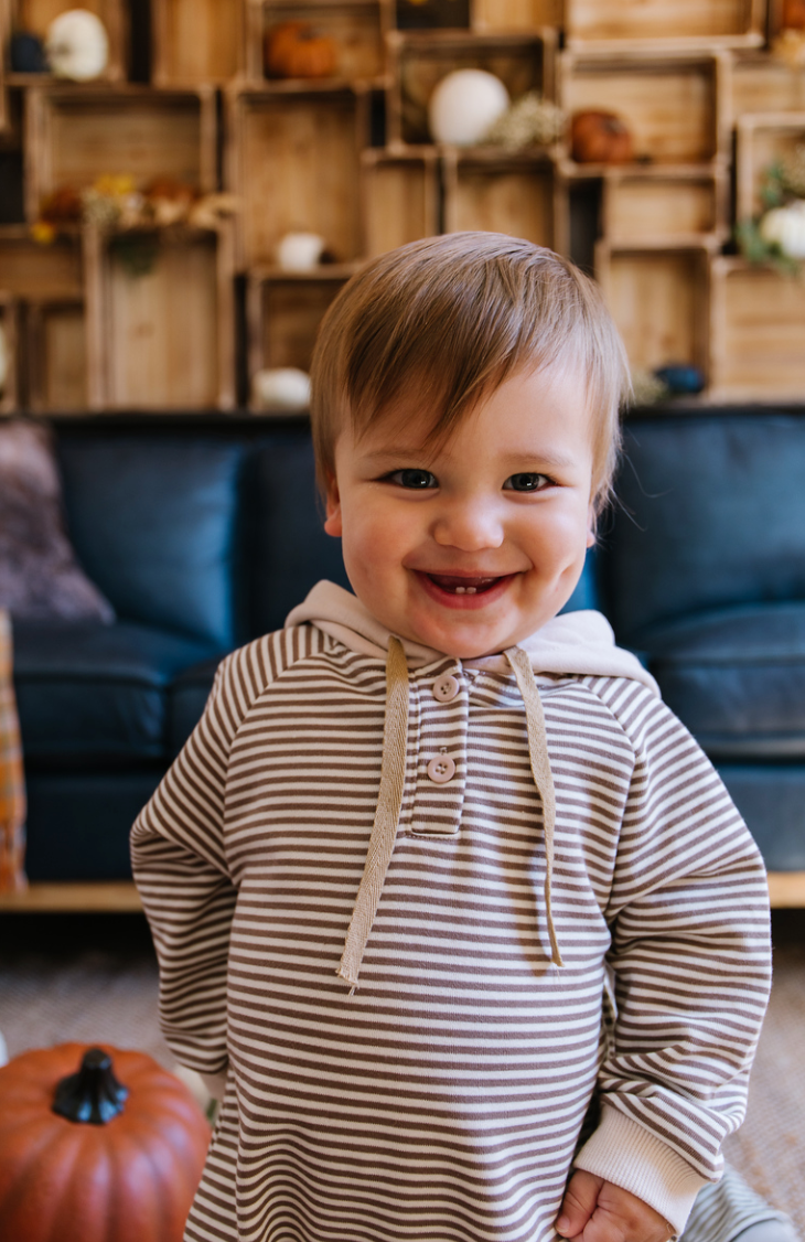 A cozy Hooded Striped Sweatshirt Jumpsuit for babies, featuring a trendy striped pattern and a convenient front zipper.