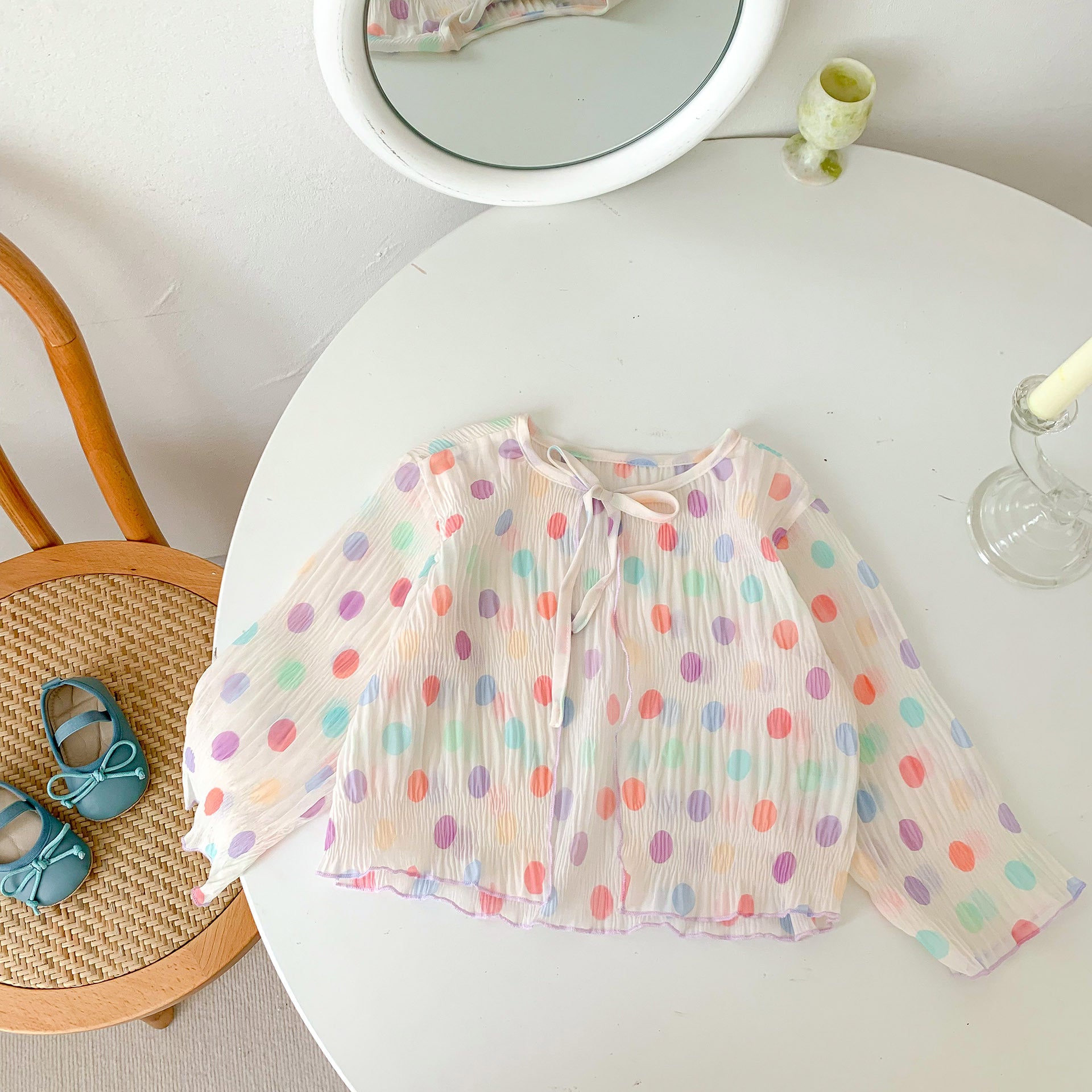 A summer outfit for baby girls featuring colorful polka dots on a beige background, made from breathable cotton.