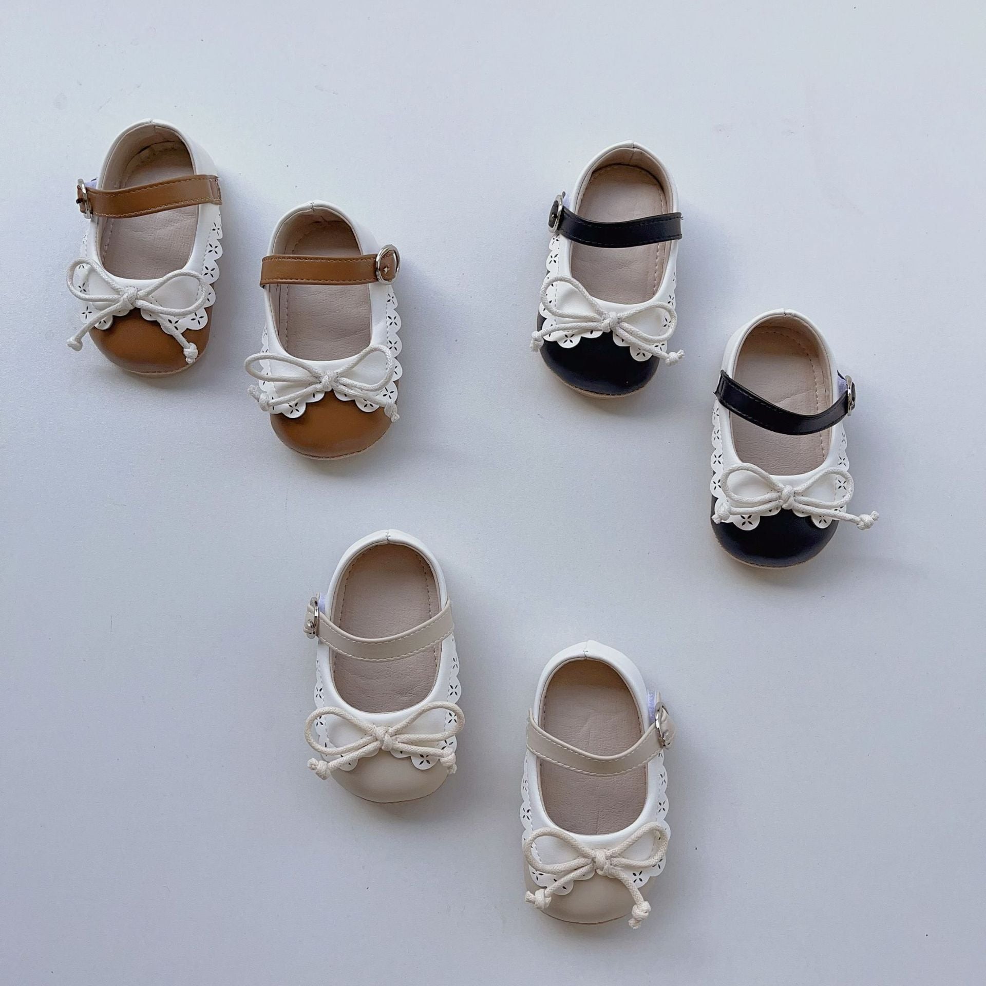 Summer Baby Girl Shoelace Bow Toddler Soft-Sole Anti-Slip Walking shoes in white, black, and brown colors with a cute bow design.