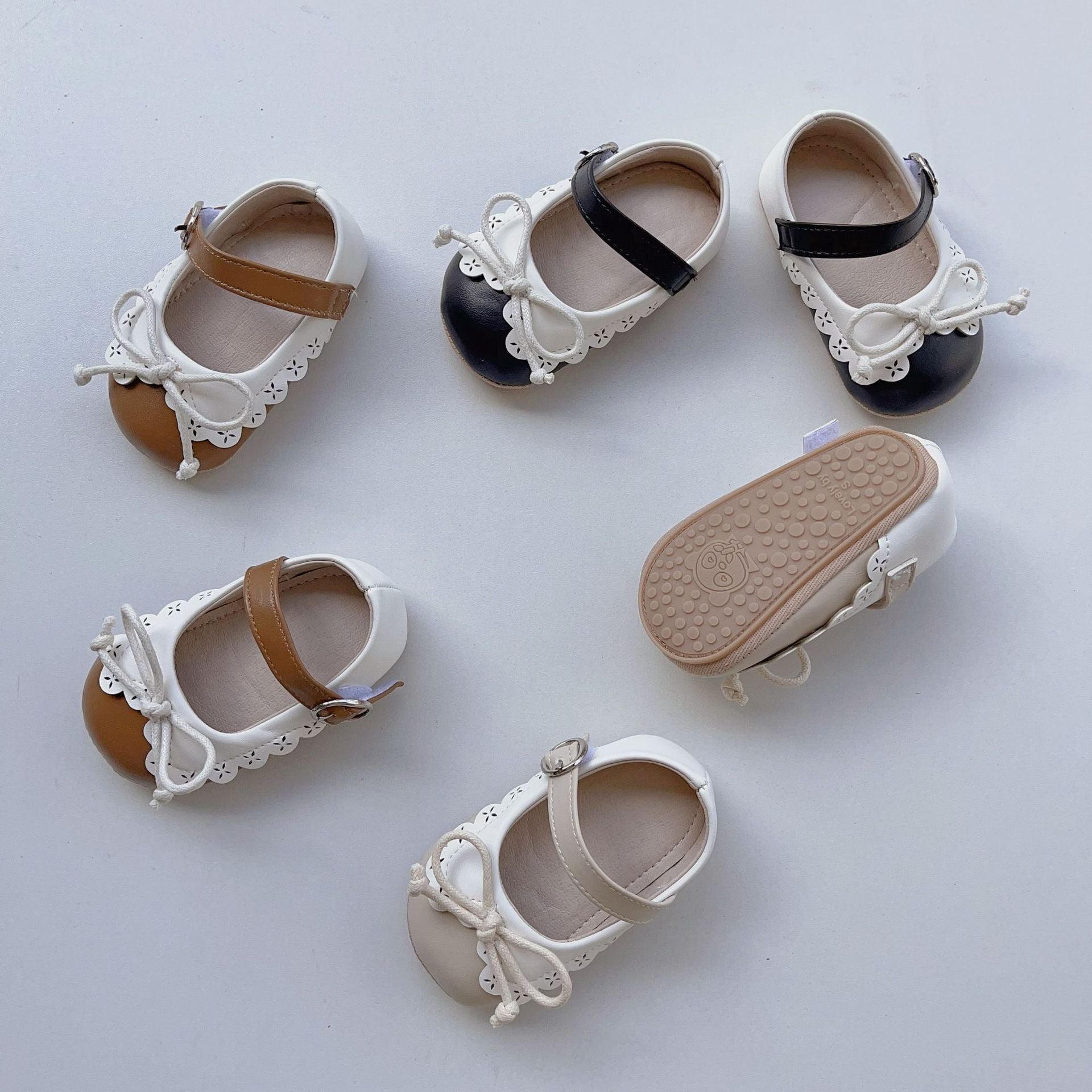 Summer Baby Girl Shoelace Bow Toddler Soft-Sole Anti-Slip Walking shoes in white, black, and brown colors with a cute bow design.