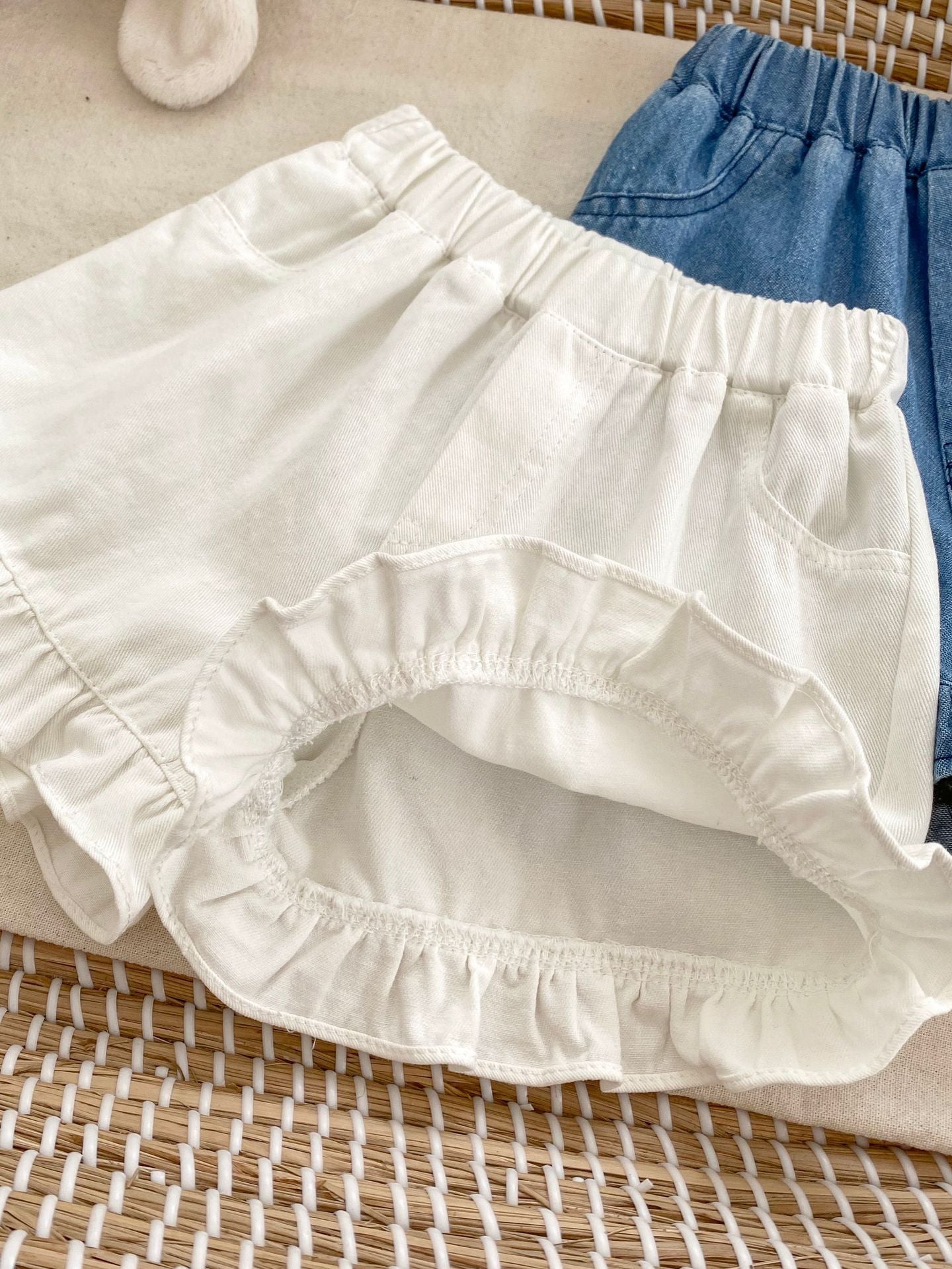 Summer Baby Girl Solid Color Ruffle Trim Denim Shorts in white and blue, featuring a cute ruffle trim design.