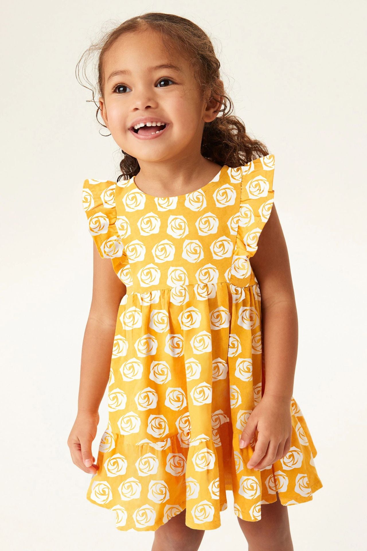 A sleeveless white dress for baby girls featuring a floral rose pattern, perfect for summer wear.