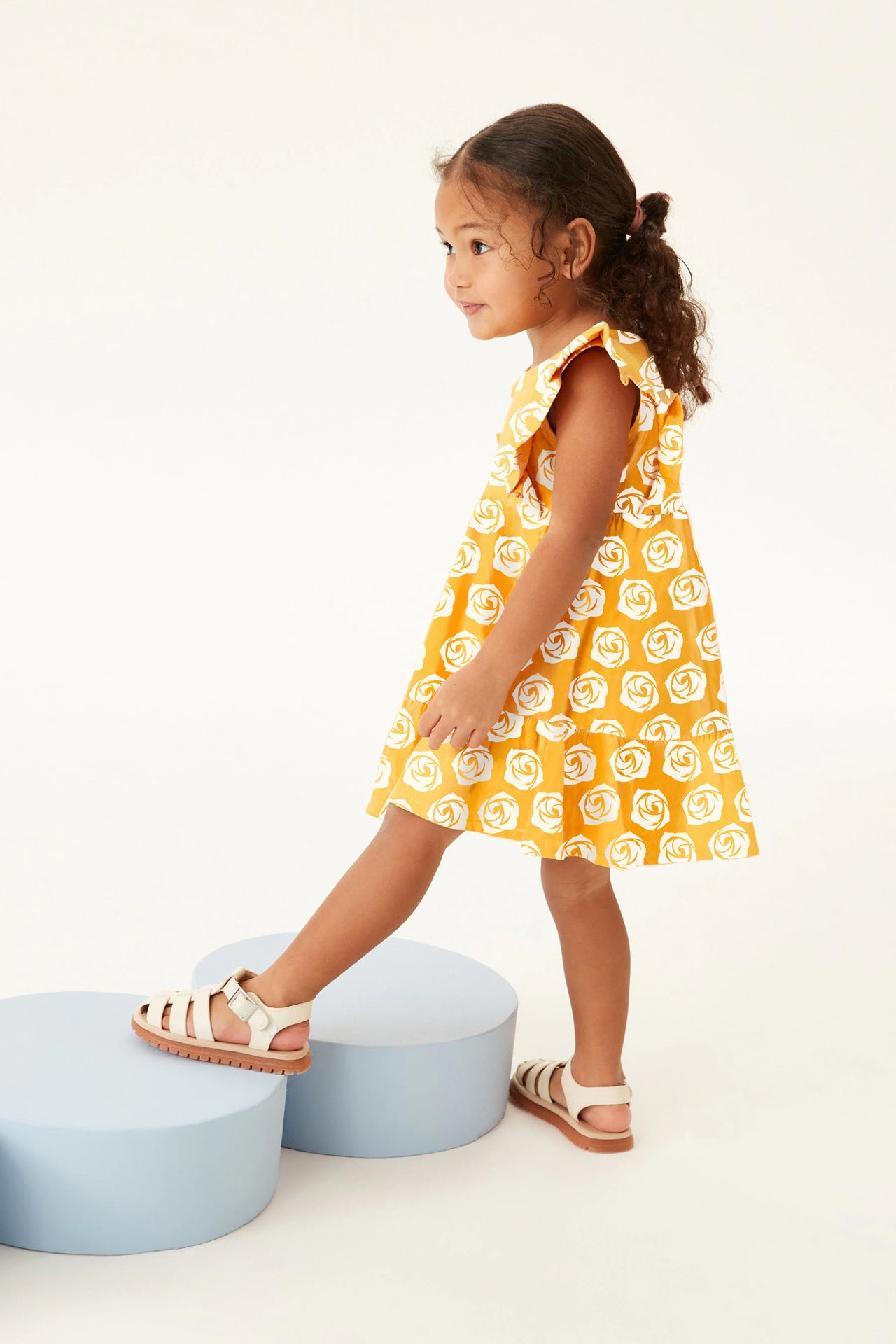 A sleeveless white dress for baby girls featuring a floral rose pattern, perfect for summer wear.