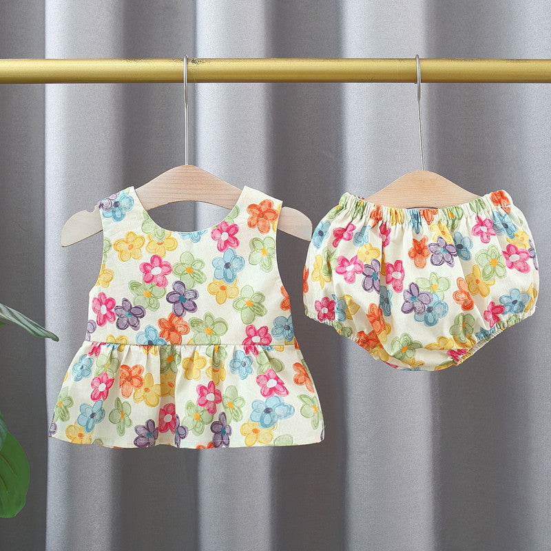 A vibrant sleeveless top dress for baby girls featuring a colorful floral pattern, perfect for summer wear.