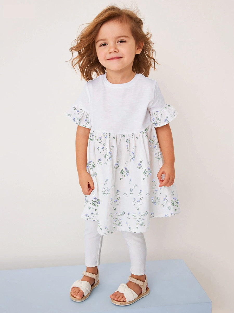 A stylish summer outfit for baby girls featuring a floral print patchwork dress and white pants, perfect for warm weather occasions.