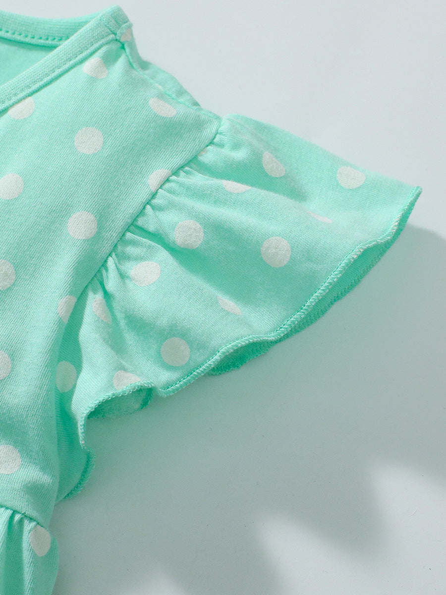 A vibrant green dress with polka dots for girls, paired with solid color shorts, perfect for summer outings.