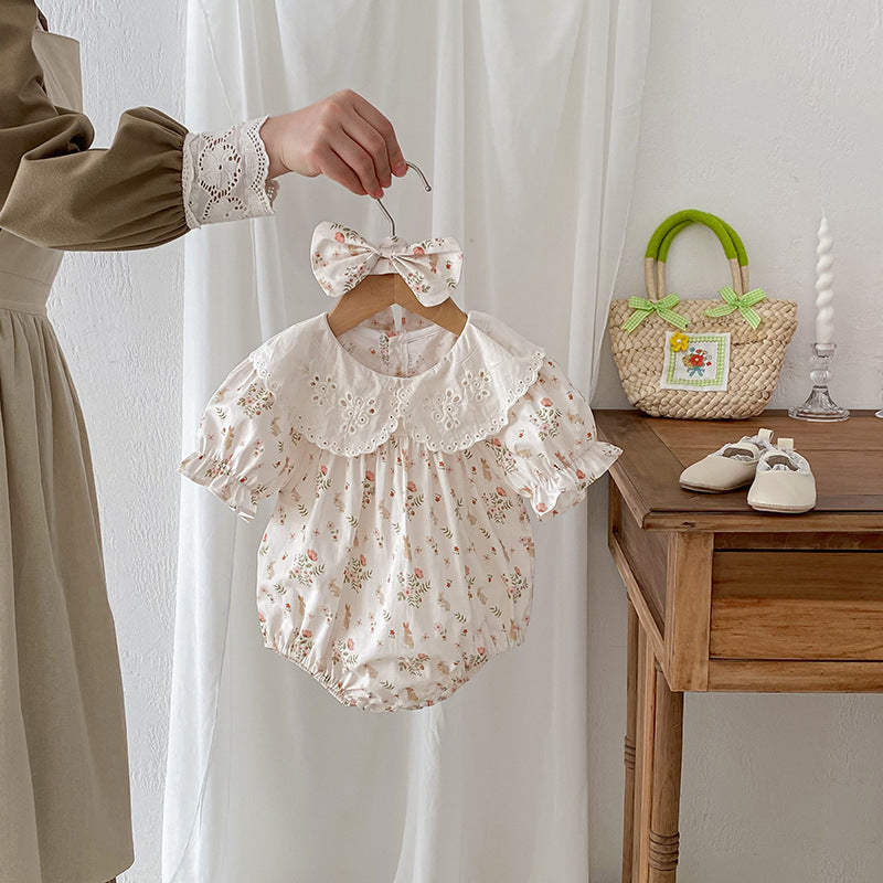 A stylish summer top for girls featuring a floral and animal pattern, short sleeves, and a hollow-out design in beige and apricot colors.