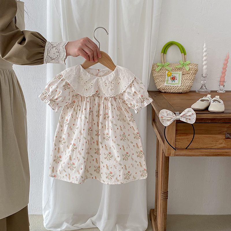 A stylish summer top for girls featuring a floral and animal pattern, short sleeves, and a hollow-out design in beige and apricot colors.