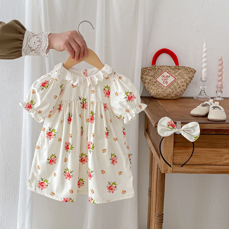 A cute summer top for girls featuring a floral pattern, short sleeves, and a hollow out ruffle collar in beige and apricot colors.